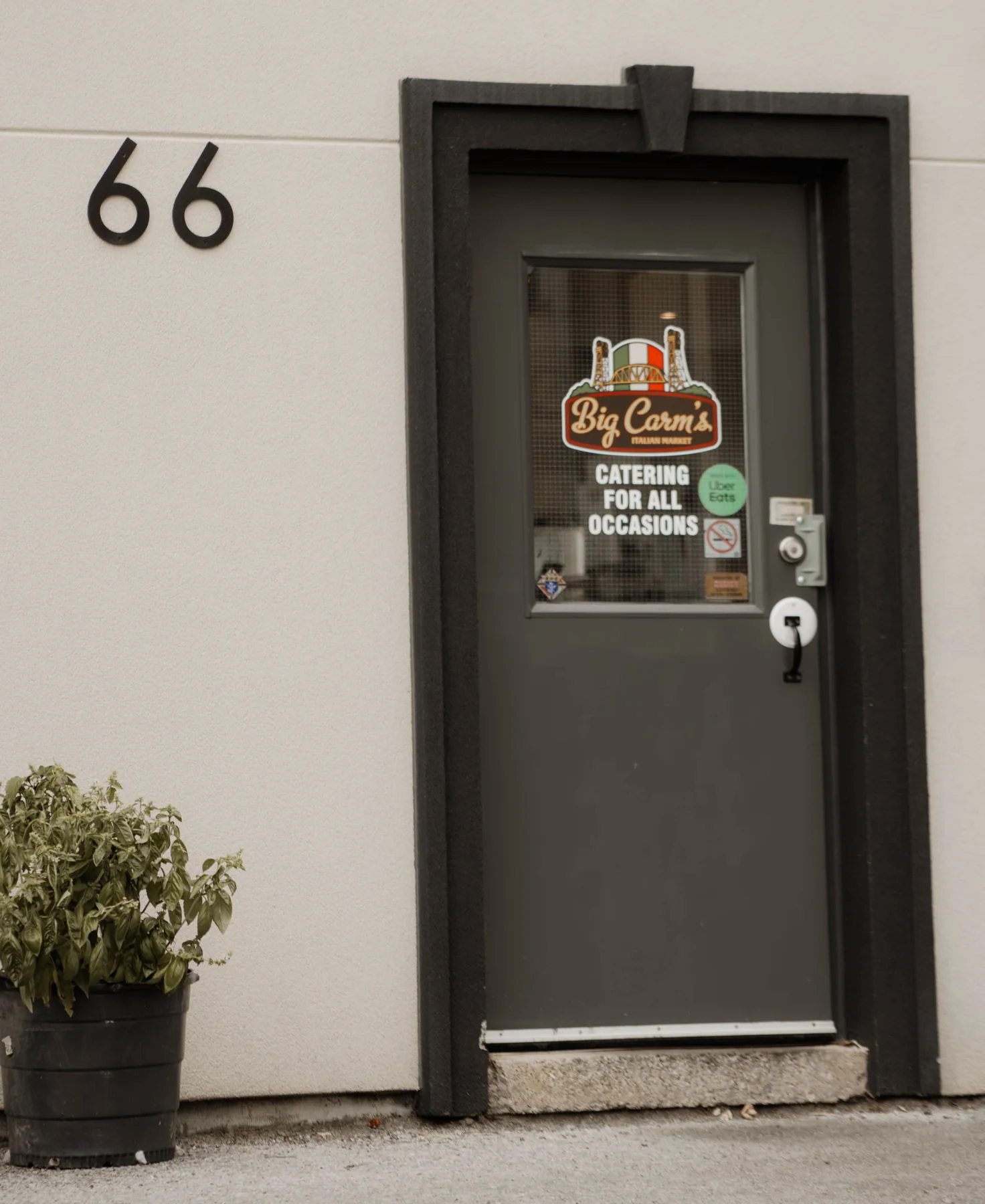 The door at 66 Division Street with a Big Carm’s catering sign